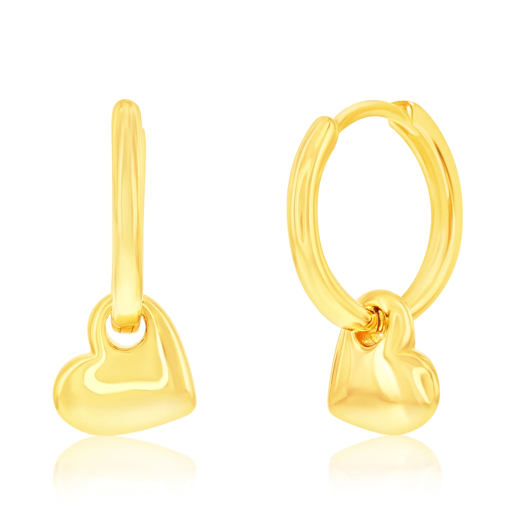 Gold hoop earrings with dangling heart charms.