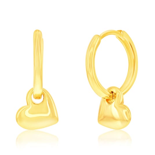 Gold hoop earrings with dangling heart charms.