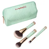 A mint green MAC cosmetics bag is displayed alongside three makeup brushes with matching handles and rose gold accents.