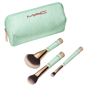 A mint green MAC cosmetics bag is displayed alongside three makeup brushes with matching handles and rose gold accents.
