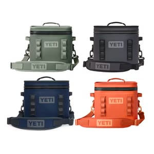 Four YETI brand soft coolers in different colors: olive green, black, navy, and orange.