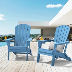 Two blue Adirondack chairs with armrests and slatted backs are on a wooden deck by a pool. Each chair has a cushion and a glass of orange juice.