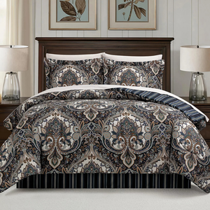 A bedding set featuring a paisley pattern in neutral tones is displayed with matching pillow shams, set in a well-lit bedroom with dark wood furniture and minimalistic decor, including two table lamps and botanical artwork above the bed.