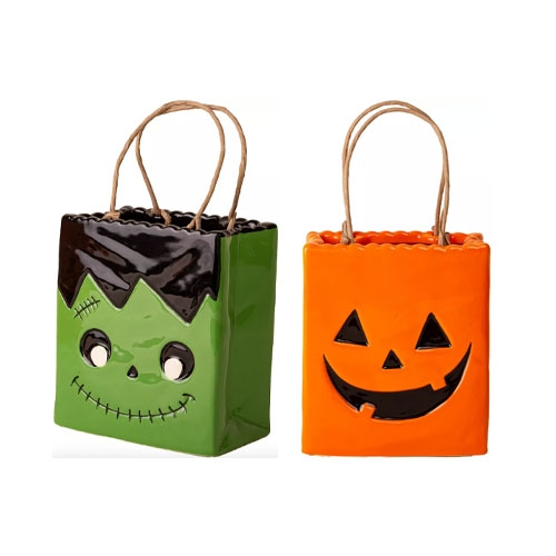 Ceramic bags with handles in Halloween-themed designs: green with a Frankenstein face and orange with a jack-o'-lantern face.