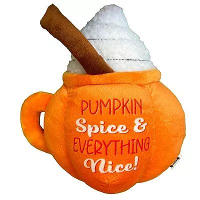A plush dog toy shaped like an orange pumpkin spice latte mug with \“Pumpkin Spice & Everything Nice!\“ text and a cinnamon stick accent.