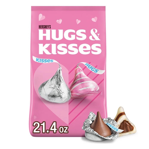 A 21.4 oz bag of Hershey's Hugs & Kisses, featuring foil-wrapped chocolates including silver Kisses and striped Hugs with a creamy filling.