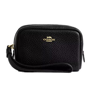A black Coach Outlet pouch wristlet made of pebbled leather with a gold logo on the front. It features a zipper closure and an attached wrist strap for convenience.