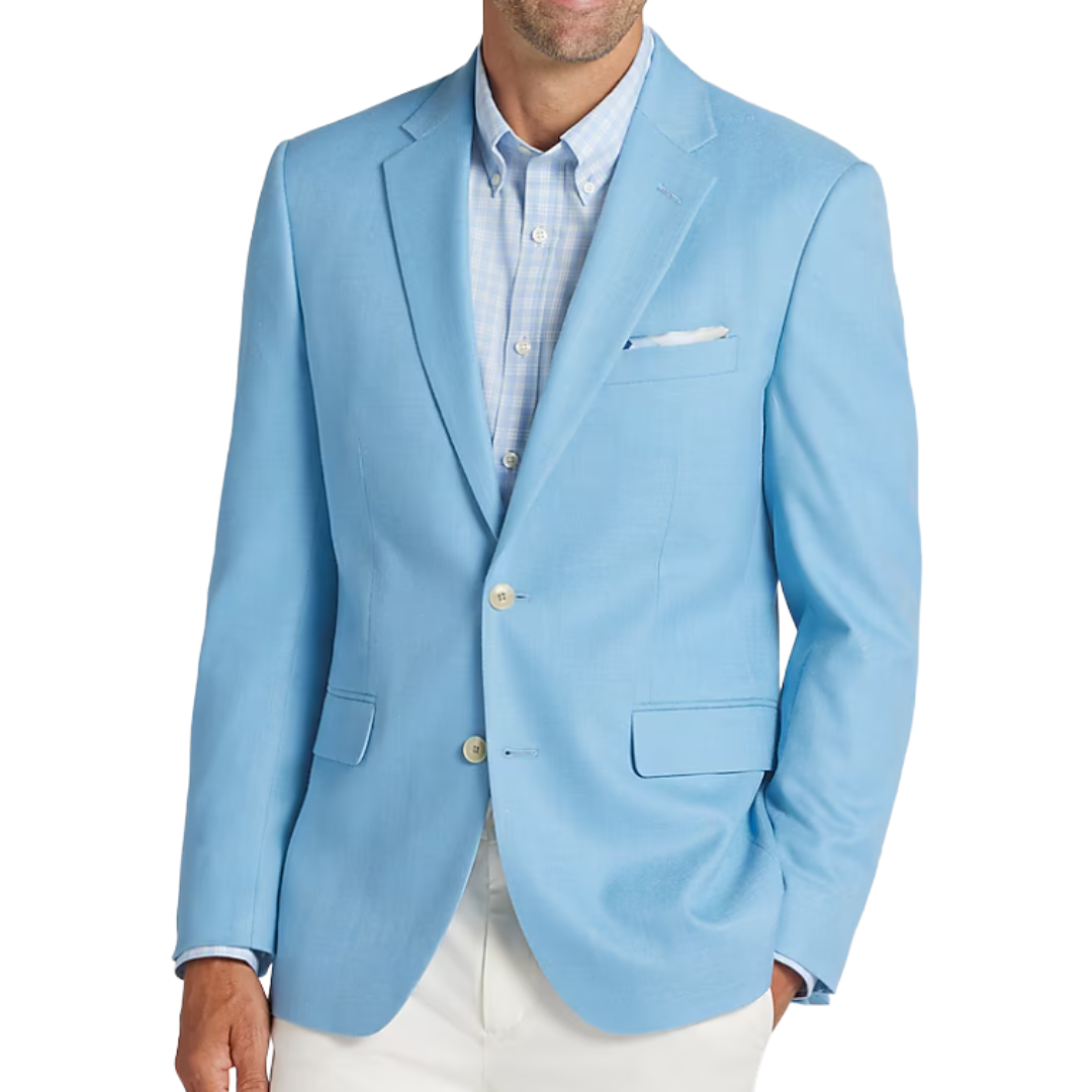 A man wearing a light blue blazer over a light blue checkered shirt and white pants.