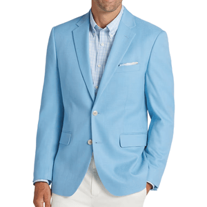 A man wearing a light blue blazer over a light blue checkered shirt and white pants.