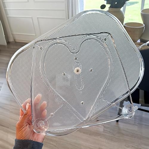 A transparent, heart-shaped Lazy Susan made of mesh material, equipped with suction cups for attachment.