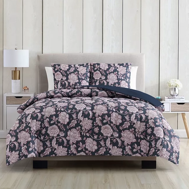 A bed with floral-patterned bedding set including a duvet cover and pillows.