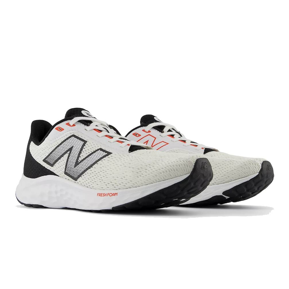 A pair of New Balance running shoes with a white and black mesh upper, red accents, and Fresh Foam soles designed for comfort and support.