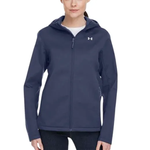 Woman wearing a navy hooded jacket with a white Under Armour logo on the chest, paired with dark jeans.