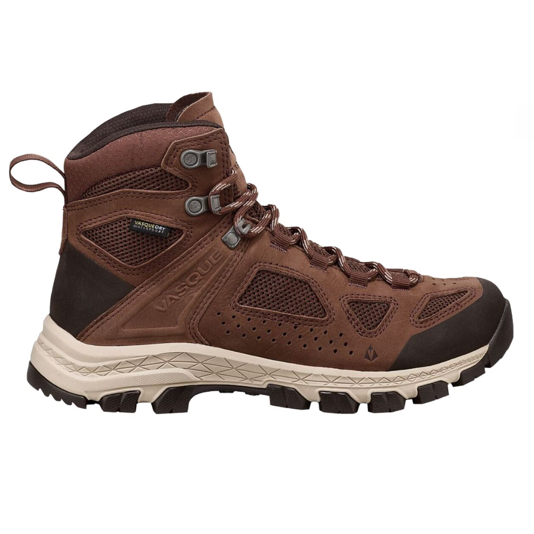 Vasque Breeze Hiking Shoes are brown, mid-height boots with a mesh and leather upper for breathability, a durable rubber sole for traction, and metal eyelets for secure lacing. Designed for comfort and rugged outdoor use.