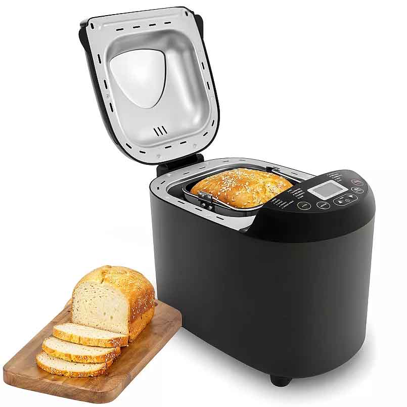 A black bread machine with 19 pre-set programs is shown with a loaf of bread inside. It features a digital control panel and includes a freshly baked, sliced loaf on a wooden cutting board next to it.