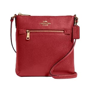 Red Coach Outlet crossbody file bag with a front zip pocket, gold-tone hardware, and an adjustable strap.