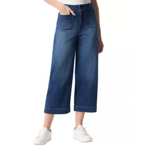 Wide-leg cropped denim jeans with front patch pockets, paired with white casual sneakers.