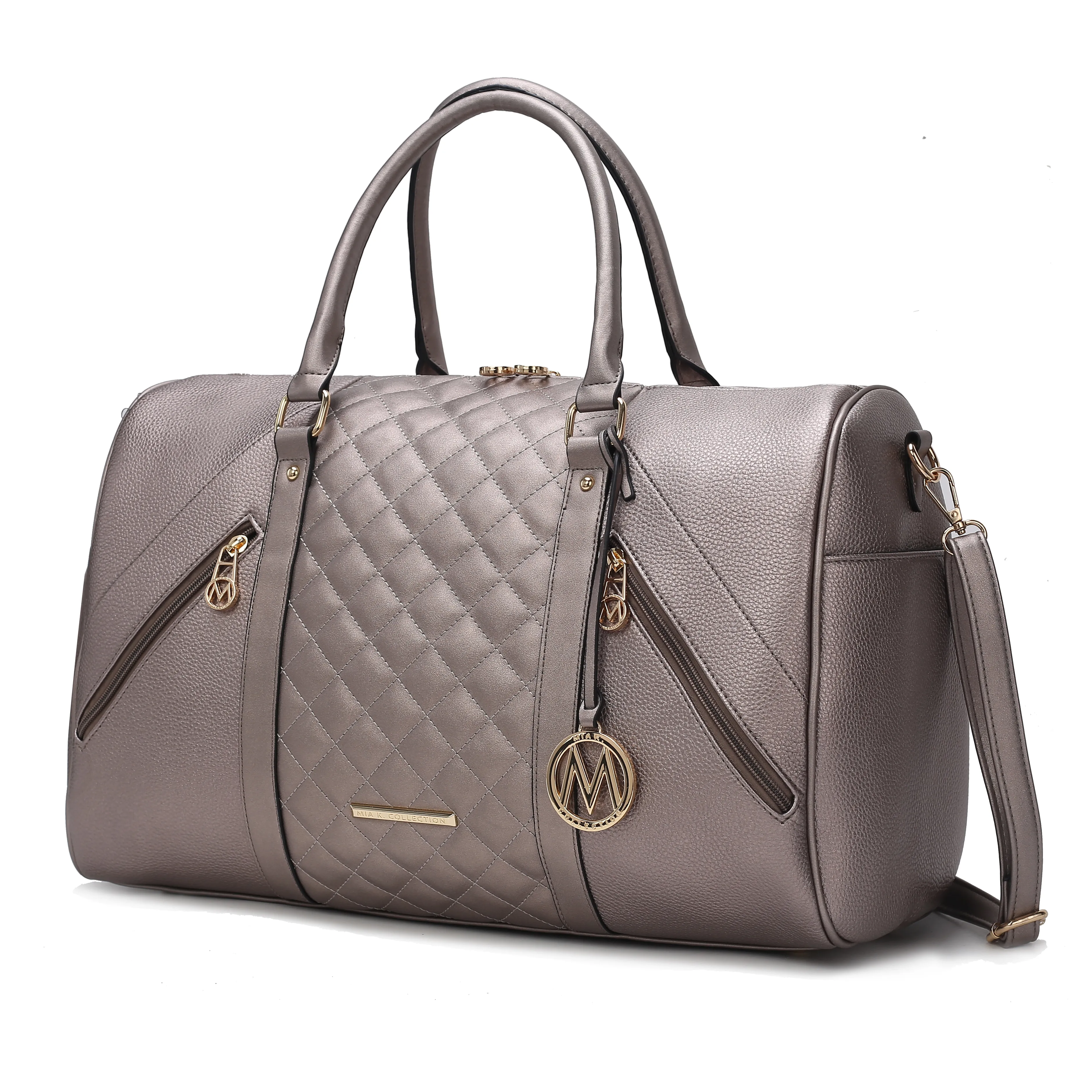A gray, quilted duffel bag with gold accents, featuring dual handles, a detachable shoulder strap, and two vertical zippered pockets accented with a circular monogram charm.