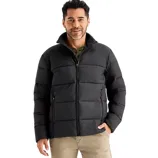 A man is wearing a black puffer jacket with a front zipper and side pockets, paired with beige pants.