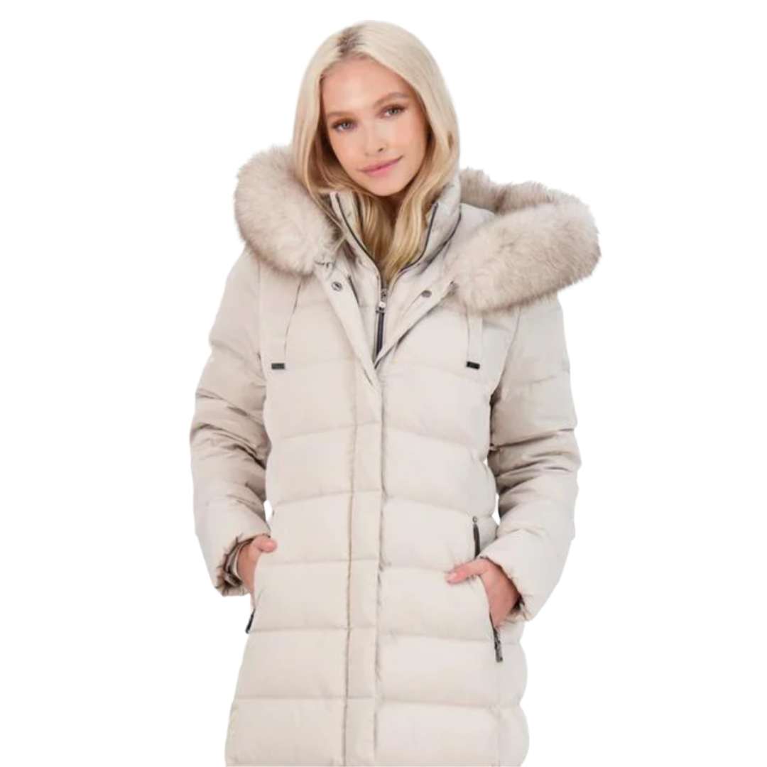 A woman is wearing a light beige puffer coat with a fur-trimmed hood. The coat has a front zip closure and side pockets.