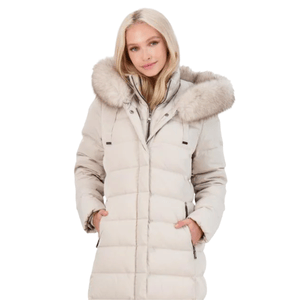 A woman is wearing a light beige puffer coat with a fur-trimmed hood. The coat has a front zip closure and side pockets.