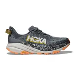 A Hoka trail running shoe with a grey, black, and orange color scheme, featuring a Vibram outsole for traction.