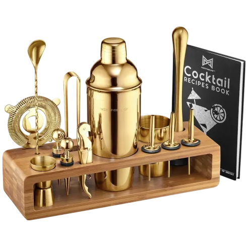 Gold cocktail shaker set with various bar tools, including a shaker, strainer, muddler, jigger, and a recipe book, all housed in a wooden stand.