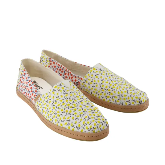 Pair of slip-on shoes featuring a floral pattern with red and yellow accents, a beige sole, and minimal branding on the insole.