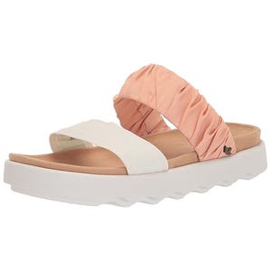 A sandal featuring a white front strap and a ruched peach-colored back strap. The sole is thick and white with a wavy pattern.