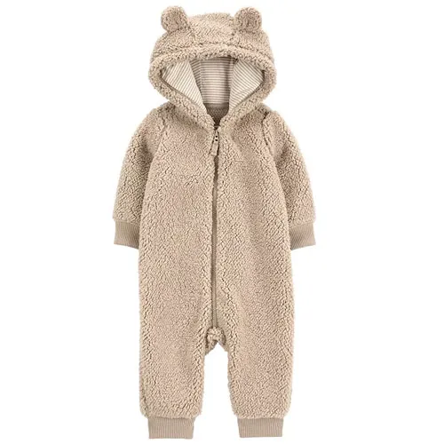 A beige, fluffy infant onesie with a hood and bear ears, featuring a front zipper and ribbed cuffs at the wrists and ankles.