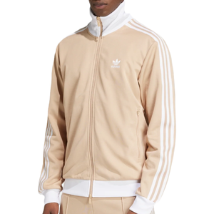 Adidas track jacket in beige with white stripes on the sleeves, featuring a zip-up front, high collar, and the Adidas logo on the left chest.