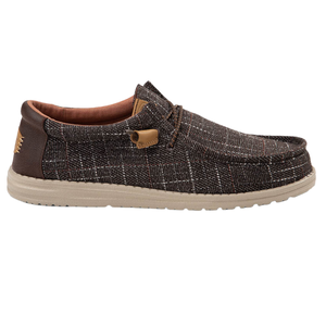 Hey Dude Men's Wally Plaid Shoes feature a brown plaid pattern with a tan sole, lace-up design, and leather accents, offering a casual and comfortable look.
