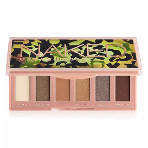 Urban Decay Naked Mini Palette contains six eyeshadow shades: Foxy, Get Down, Sly, Hot Stuff, Disco, and Funky Town, housed in a compact case with bold green and black design accents.