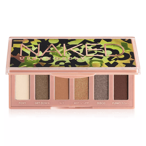 Urban Decay Naked Mini Palette contains six eyeshadow shades: Foxy, Get Down, Sly, Hot Stuff, Disco, and Funky Town, housed in a compact case with bold green and black design accents.