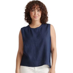 Sleeveless navy tank top made from 100% European linen, featuring a slightly relaxed fit with a crew neckline. The top is paired with white pants.