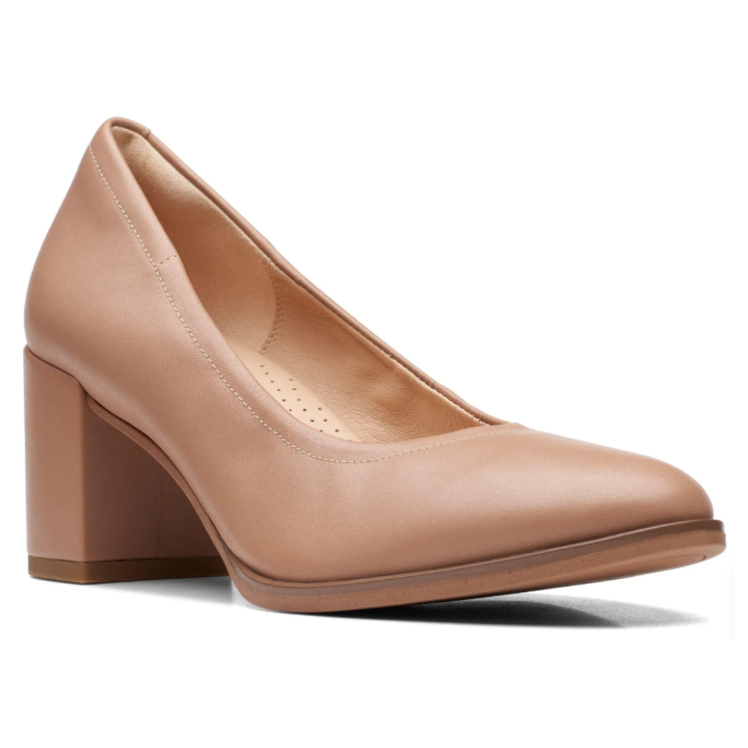 A nude-colored, closed-toe high heel shoe with a chunky block heel, offering a classic and versatile design.
