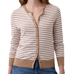 A striped cardigan with tan and white horizontal stripes, featuring a button-up front and ribbed accents at the cuffs and hem, paired with blue jeans.