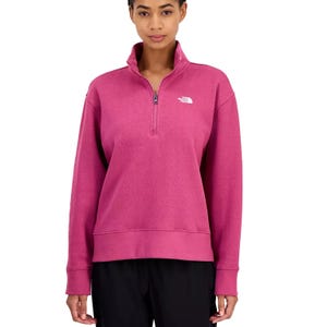 Pink half-zip sweatshirt with a white The North Face logo on the chest.