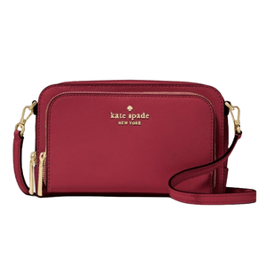A red Kate Spade New York crossbody bag with gold zippers and an adjustable strap.