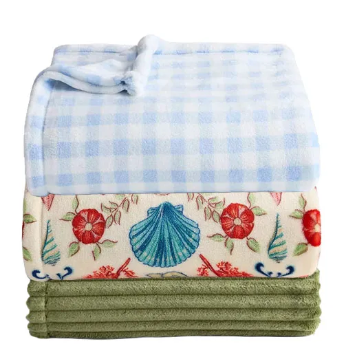Three folded blankets: a blue and white checkered one, a floral one with seashell and flower patterns, and a plain green one.