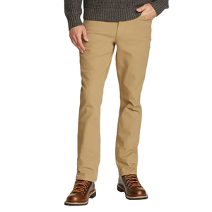 A person is wearing beige pants paired with brown leather lace-up boots and a charcoal gray knit sweater.