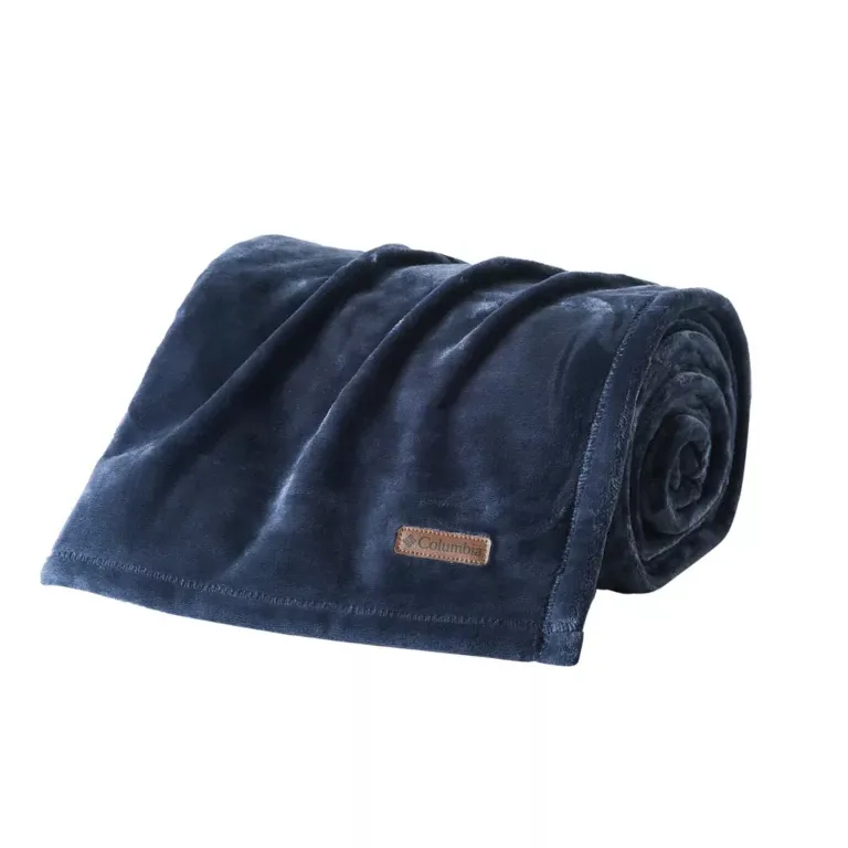 Rolled-up navy blue fleece blanket with a brown label.