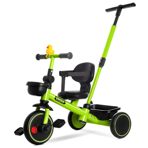 A green children's tricycle with a rear push handle, rubber duck decoration, and black seat. It features a front storage basket, three wheels, and pedals on the front wheel.