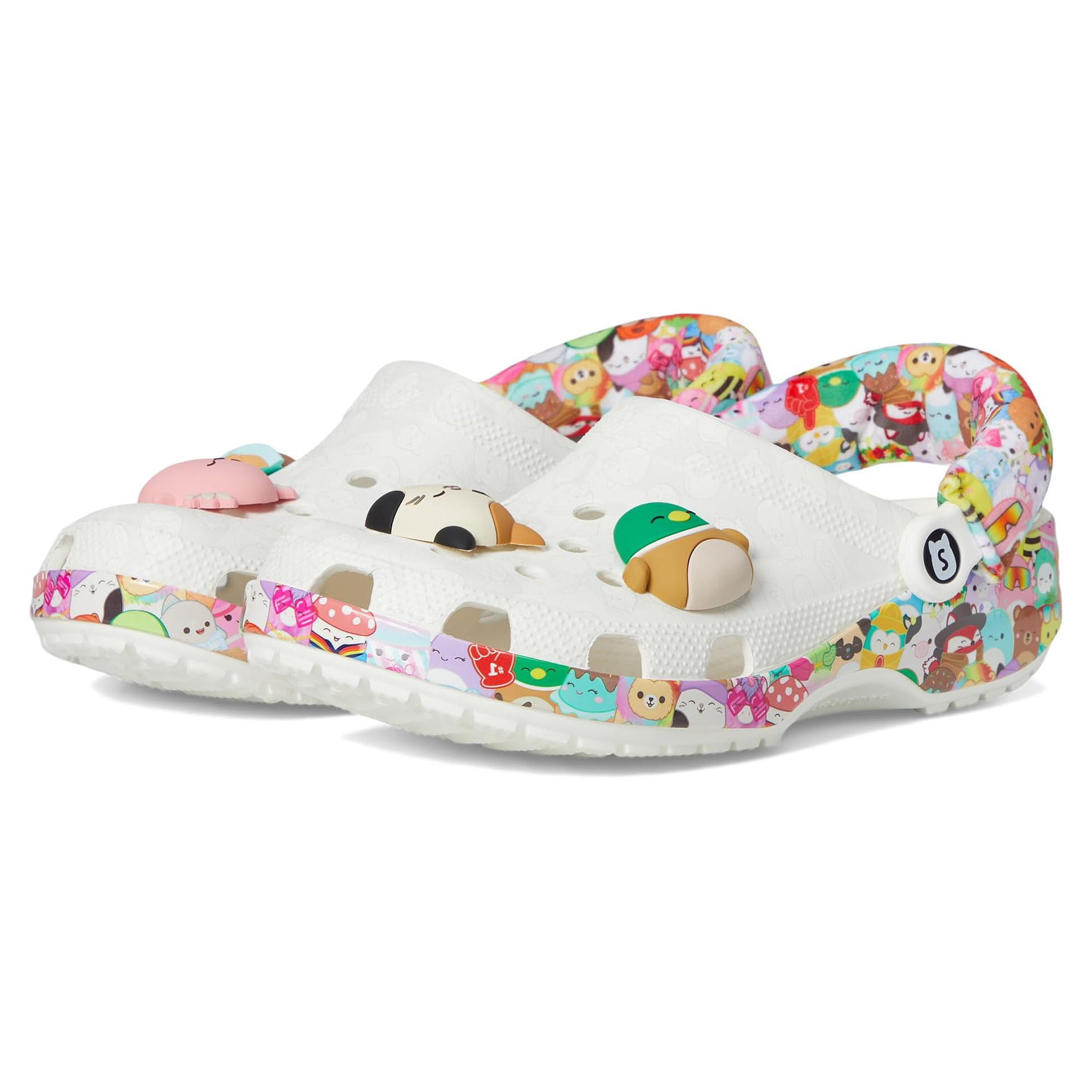 White Crocs clogs feature colorful Squishmallows character designs on the strap and base, with various character charms on the upper, creating a playful and vibrant look.