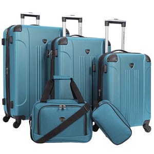 The Travelers Club 5pc Luggage Set includes three hardshell suitcases of varying sizes with telescopic handles and spinner wheels, a duffel bag with a shoulder strap, and a small toiletry/accessory bag, all in a matching teal color.