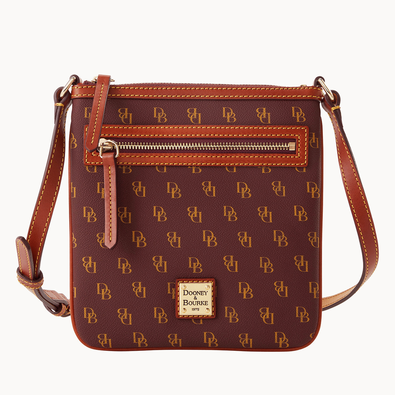 Brown crossbody bag with a printed monogram pattern and leather trim.