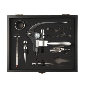 The 9-piece wine accessory set includes a lever-style corkscrew, foil cutter, bottle stopper, pourer, thermometer, drip ring, spare worm screw, and an additional stopper, all housed in a black gift box.