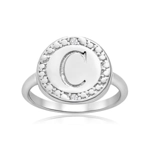 Sterling silver ring featuring a central circular design with the letter \“C,\“ surrounded by a border of small diamonds. The band is sleek and minimalist.
