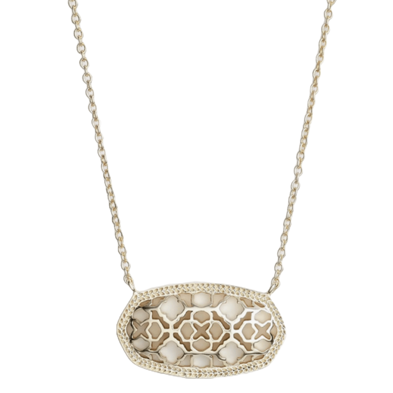 A gold-tone necklace features a flat, oval pendant with a cut-out quatrefoil pattern and a textured edge, hanging from a delicate chain.