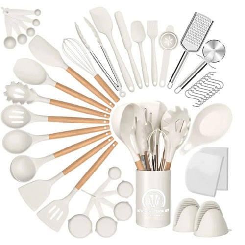 A 44-piece white kitchen utensil set with wooden handles includes spatulas, spoons, tongs, whisks, measuring spoons, grater, peeler, and more, all housed in a matching canister.